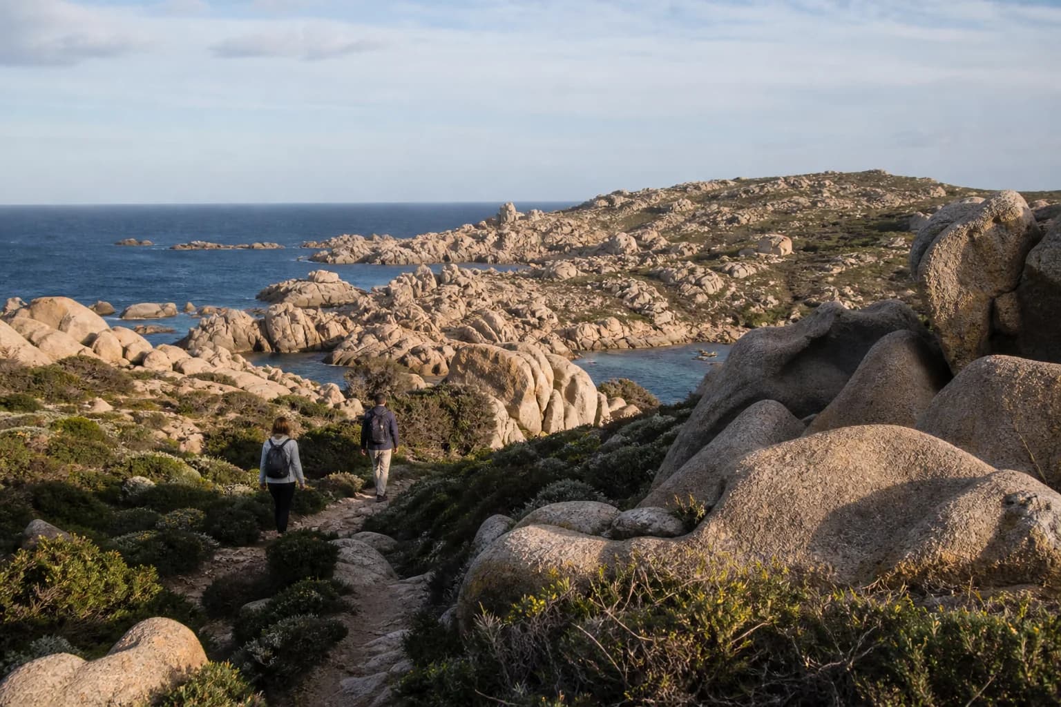Hikers on the Capo Testa coastal path