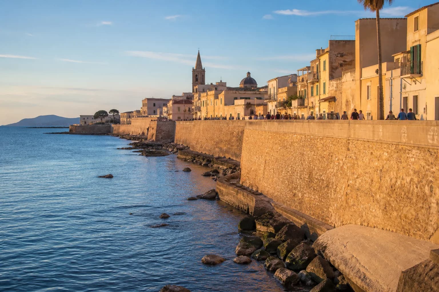 Alghero ramparts and old town overlooking the sea at sunset
